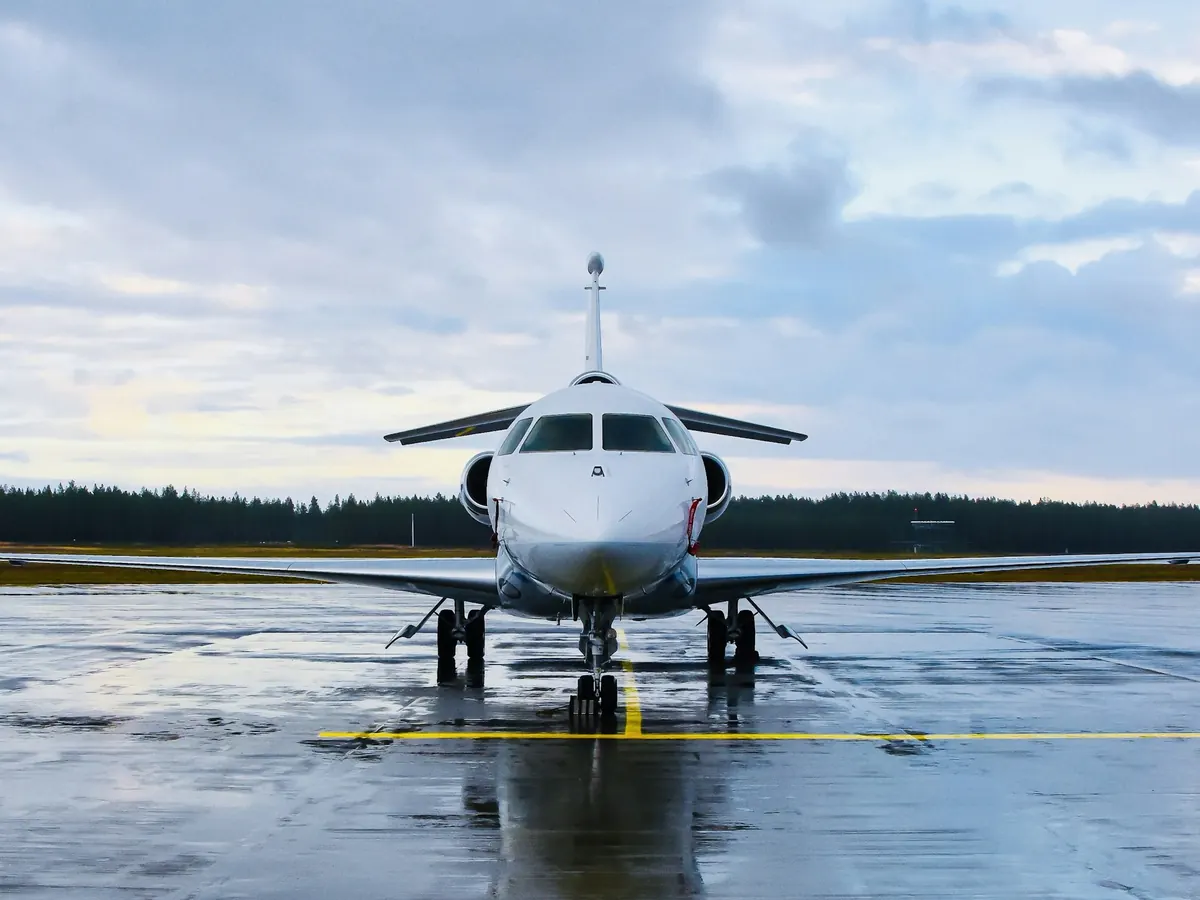 Business jet facing the camera on a wet runway